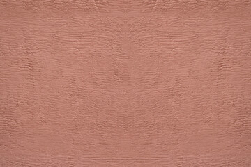 Fototapeta premium red pink plaster wall texture. Seamless surface abstract solid background Pale painted wall built structure textured stucco in terracotta color. seamless texture of plaster backdrop pattern Peach Fuzz