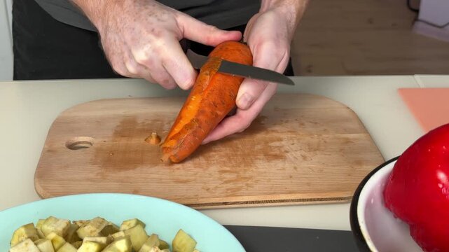 Peeling Orange Yam. Scene Showing Detailed Peeling Process Of Orange Yam With Knife On Wooden Surface