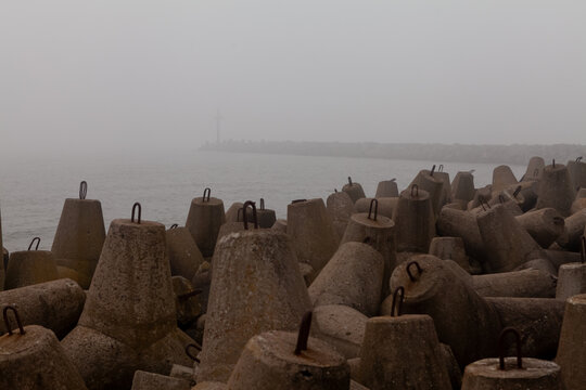 Foggy harbor with concrete tetrapods