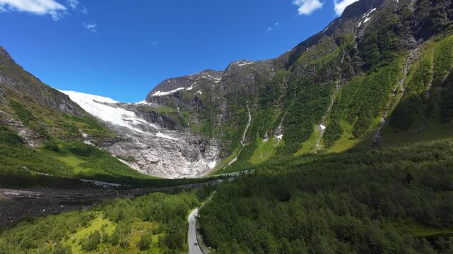 Aerial reveal pan to B&oslash;yabreen glacier in Fj&aelig;rland glacial valley, Norway