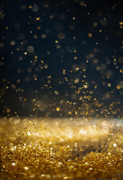 Sparkles of light dance in a dark space showing golden glimmers and reflections