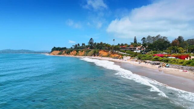 Moving from shore to the waterscape of the Pacific Ocean on sunny day. View on the picturesque green coast in Santa Barbara, California, USA.