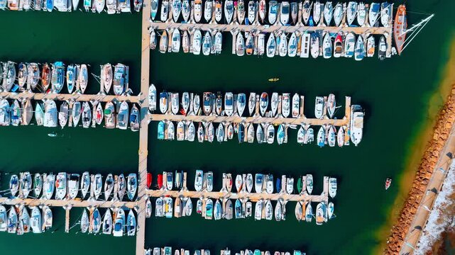 Flying high over the berths with multiple yachts and boats. Yacht club in Santa Barbara, California, USA.