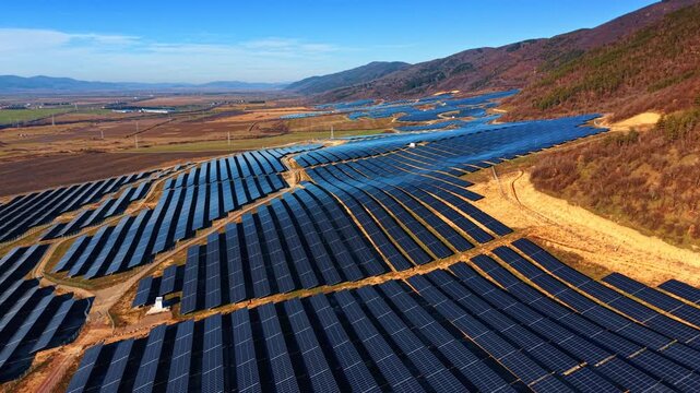 Footage over the multiple solar panels in the wilderness. Renewable energy concept.