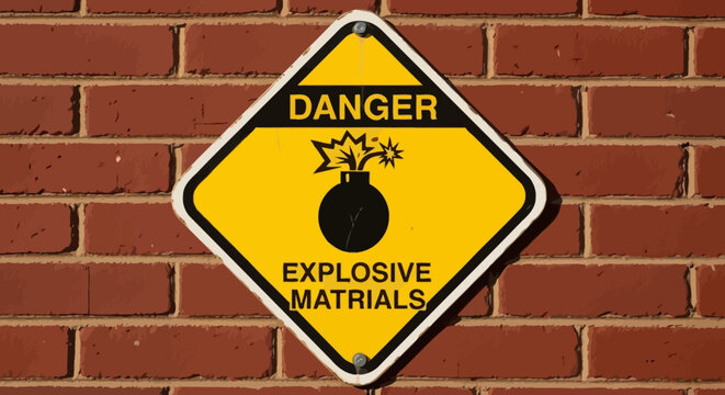 Yellow diamond danger sign with explosive materials warning symbol and text mounted on a red brick wall, representing caution and hazard.