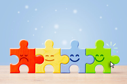 Emotional support and mental health concept with colorful puzzle pieces and sad to happy faces on blue background. Teamwork, inclusion, psychology or wellbeing communication banner.