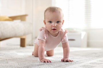 Fototapeta premium Learning to walk. Little baby crawling on floor at home