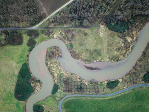 A riverloop of a muddy river on a cold autumn day,seen from above