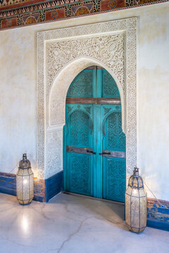 Intricate designs and a blue color. It is located in a tower of the Secret Garden in Marrakesh, Morocco. Lanterns light up the area at night.