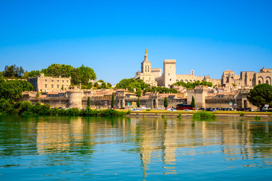 Panoramic view of the historic center, Papal Palace and ancient city walls rise above the Rhone River on a sunny summer day, Avignon, Provence, France