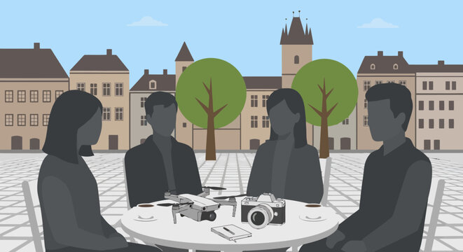 Diverse group of people gathered around a table outdoors.