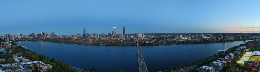 Obraz premium Panoramic aerial drone view of Boston Back Bay skyline, Prudential Tower, and Charles River Esplanade on a clear summer day, featuring historic brownstones and city skyscrapers, USA.