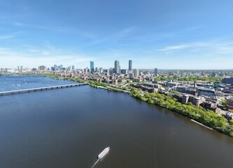 Obraz premium Aerial drone view of Boston Back Bay skyline, Prudential Tower, and Charles River Esplanade on a clear summer day, featuring historic brownstones and city skyscrapers, USA.