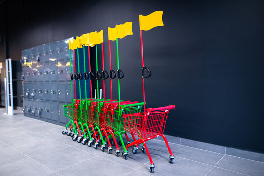Small shopping carts for children in a supermarket. Kid-friendly grocery store equipment and family shopping concept.