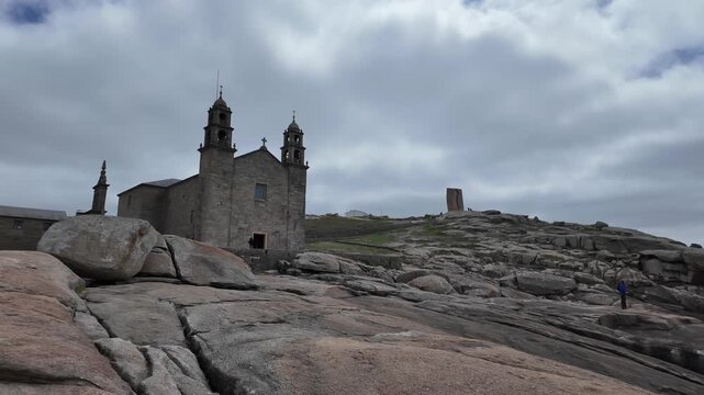 Santuario da virxe da barca church with pilgrims walking along the path by the atlantic ocean