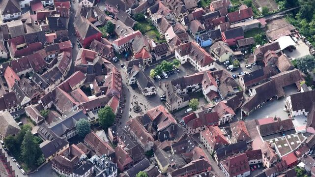 Aerial view of the historic town center of Ribeauville featuring traditional red-tiled rooftops and narrow streets in Ribeauville, Grand Est, France.