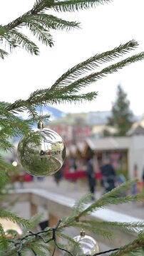Christmas Tree Ornament Close Up with Blurred Holiday Market Background