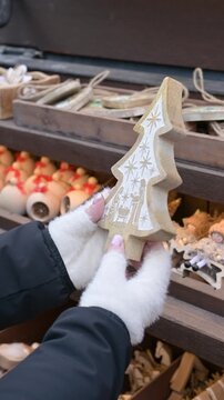Close Up Hands Choosing Christmas Decoration at Holiday Market Stall