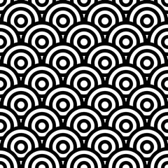 Fish scale wallpaper. Asian traditional ornament with repeated scallops. Repeated white circles and semicircles on black background. Seamless surface pattern design with rings. Vinyl motif. Vector. © funkyplayer