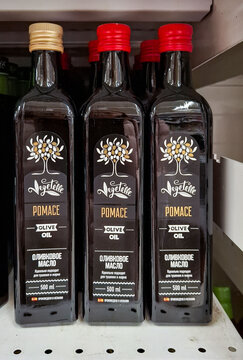 MOSCOW, Russia - March 21, 2026.Bottles of Vegetelle pomace olive oil with red caps on display in a supermarket in Russia during daytime shopping hours