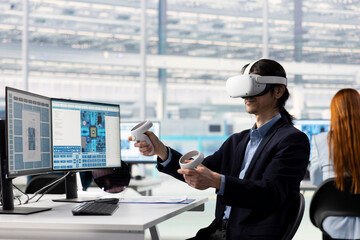 Fototapeta premium Asian man testing microchip electronics prototypes using VR tech. Senior manager wearing virtual reality goggles ensures industrial hardware standards in semiconductors RD laboratory