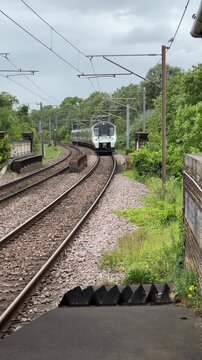 Train approaching the station platform in the countryside