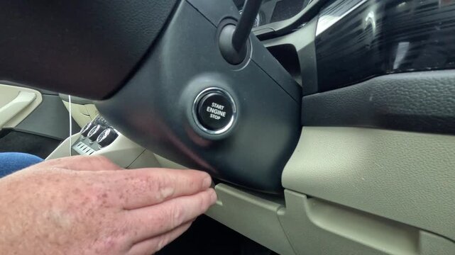 Driver Pressing Engine Start Button Inside Modern Car