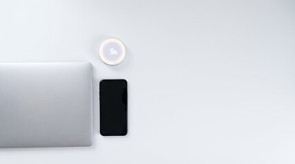 Fototapeta premium Top view of laptop smartphone and smart device with discount price tag 5 percent off display on white office desk. Promotional offer rebate e-commerce marketing. Special sale promotion with copy-space