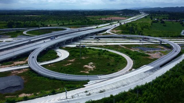 Top aerial view of an advanced highway interchange system with intersecting roads illustrates transportation efficiency, infrastructure planning, and urban mobility concepts.