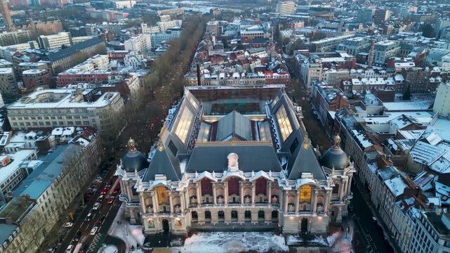 Aerial view of the Palais des Beaux-Arts de Lille with its glass roof and surrounding snow-covered rooftops Lille, Hauts-de-France, France.