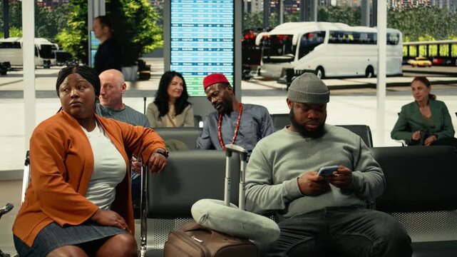 Black man browsing social media and waiting for metropolitan bus, public transportation commercial line in the city. Daily commute and convenient everyday travel, transit hub.