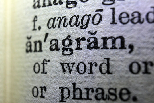 Word anagram on dictionary page, macro close up