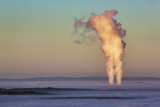 Two columns of steam rising from cloud cover, Grohnde nuclear power plant seen from K&ouml;terberg, sunset, L&uuml;gde, Weserbergland, North Rhine-Westphalia, Germany