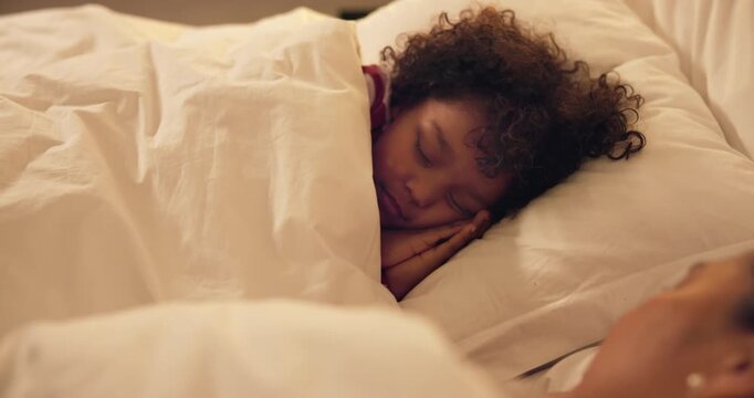 Sleeping, child and relax with mom in bedroom, home and single parent with son at night or together. Tired, family and dreaming on comfortable mattress, woman and resting with kid on bed and nap