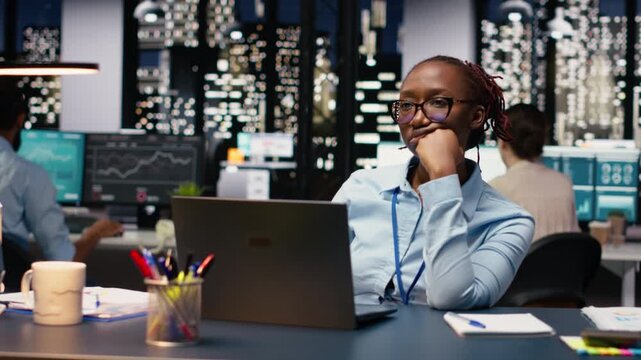Black manager thinking about new ideas while reviewing notes on laptop, focused yet pensive worker contemplates solutions. Planning strategy to improve performance metrics, business growth.