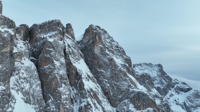Aerial view of the snow-covered jagged peaks of Parco Naturale Paneveggio Pale di San Martino in Primiero San Martino di Castrozza, Trentino-Alto Adige, Italy.