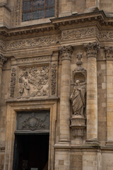 Obraz premium Vertical view of ancient baroque cathedral facade. Detailed stone carvings, columns and holy statues. Abstract historic european architecture background. High resolution 33MP. 