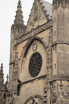 Epic Bordeaux Saint Michael basilica ancient gothic architecture vertical panorama. 
Cinematic low angle view of historic medieval cathedral facade, 
stone spire towers, vintage clock, arch and green 