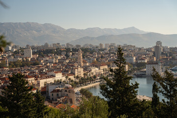 Obraz premium Horizontal aerial panorama of historic coastal city resort. Scenic mediterranean promenade with palm trees, old palace and cathedral tower in Split, Croatia. 