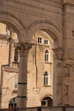 Epic Split Diocletian palace peristyle panorama. 
Cinematic ground view of ancient Roman limestone 
colonnade arches and historic venetian buildings 
in old town Split, Croatia.
