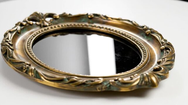 Ornate Antique Mirror with Golden Frame and Dark Reflective Surface, Decorative Elegant Object
