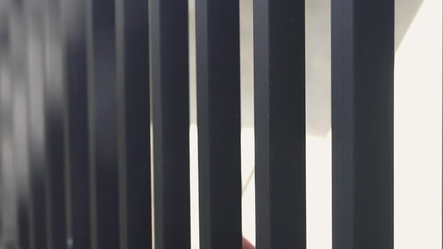 Close-up of hands exchanging Indonesian rupiah through prison bars, symbolizing bribery, corruption, illegal transactions, and criminal activity. Concept of fraud, dishonesty, and justice issues.