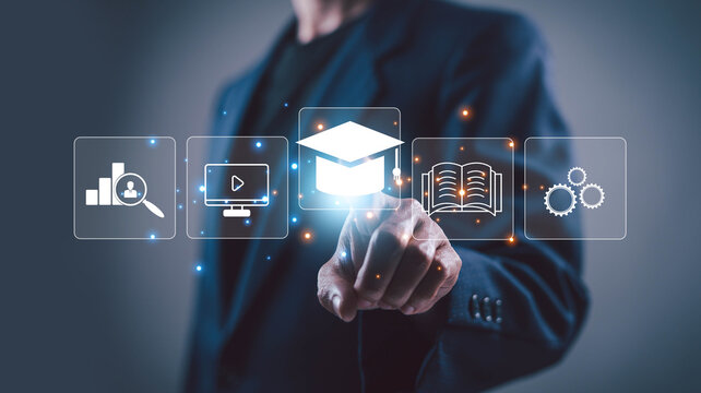 Business professional selecting digital education icons on virtual interface, symbolizing online learning, e-learning, skill development, training, academic growth and education technology.