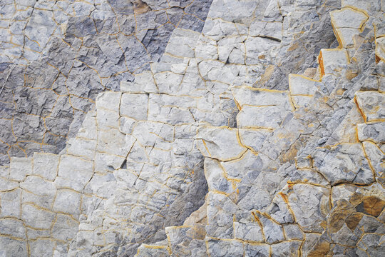View of the unique geological rock formations and textured stone layers at Playa de Sopelana in Vizcaya, Pais Vasco, Spain.