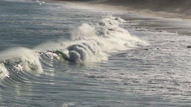 Ocean waves break and crash onto the shore in Port Elliot South Australia in 4k video footage