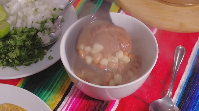 Mexican food, a typical dish from northwest Mexico (Sonora) with corn and cooked beans, with beef in soup with cilantro and chopped onion, GALLINA PINTA, with corn tortillas on the side	

