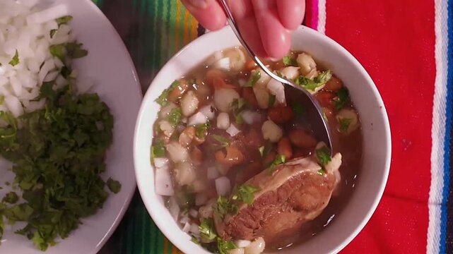 Mexican food, a typical dish from northwest Mexico (Sonora) with corn and cooked beans, with beef in soup with cilantro and chopped onion, GALLINA PINTA, with corn tortillas on the side	
