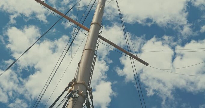 Sailing Ship Mast Against Cloudy Blue Sky