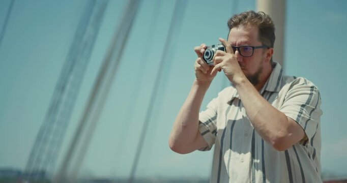 Man Using Camera on Cruise Ship Deck with Ocean View