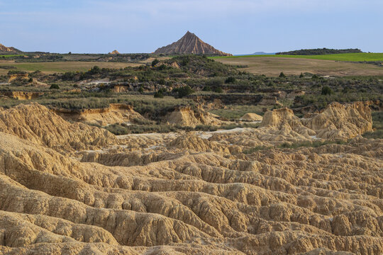 View of the unique semi-desert landscape of Bardenas Reales with its eroded clay formations and rugged hills under a clear sky Navarre, Spain.